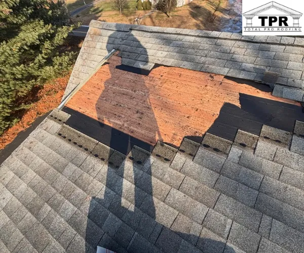A section of a residential roof with missing shingles