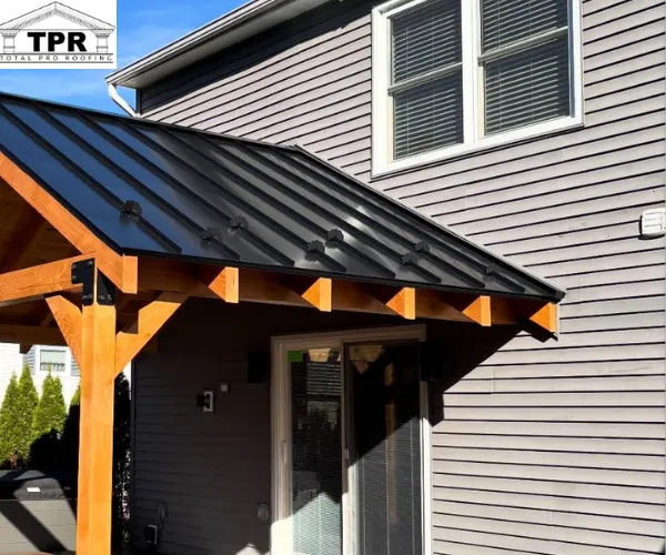 A back deck attached to a two-story home with grey horizontal vinyl siding.